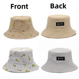 Reversible bucket hat detail in beige and grey with cute yellow duck print and logo