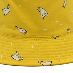 Yellow cotton bucket hat with white cartoon graffiti patterns for casual sun protection