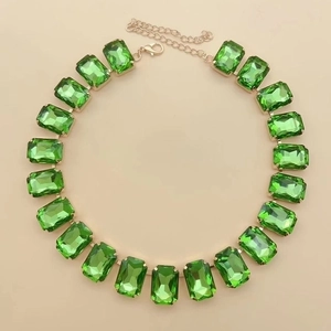 Detail of emerald green rectangular crystal necklace with gold plated setting and lobster clasp