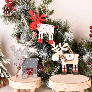 Three assorted wooden Christmas reindeer ornaments with scarves and beads on wood stand