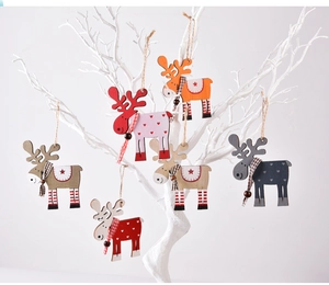 Detail of wooden reindeer ornaments with plaid scarves hanging on white branches