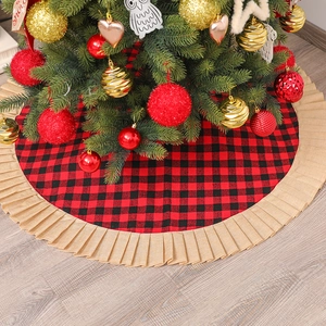 Red and black buffalo plaid Christmas tree skirt with pleated burlap trim on wood floor