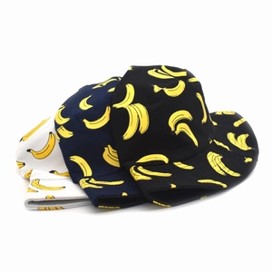 Close-up of cotton bucket hats featuring vibrant yellow banana prints in three colors