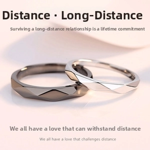 Detailed view of geometric prism cut couple rings in silver and black metal finishes