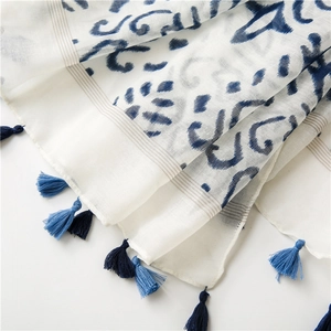 Close-up of bohemian wave print cotton linen shawl featuring blue fringe tassels