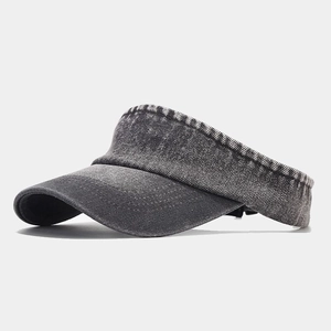 Detail view of washed denim texture and curved brim of the vintage charcoal sun visor cap