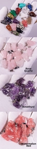 Detailed view of hand-carved natural rose quartz and amethyst angel pendants