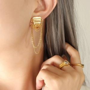 Asymmetric geometric gold fringe earrings and rings set with pearls and gemstones