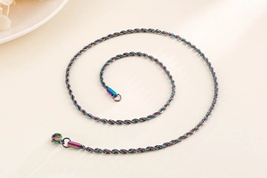 Macro shot of colorful iridescent stainless steel twist chain necklace with lobster clasp
