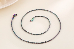 Detailed macro view of a colorful rainbow electroplated stainless steel twist rope chain