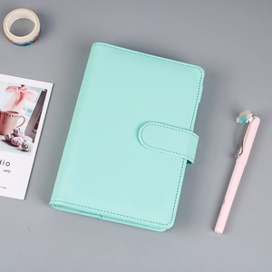 Detail of mint green PU leather notebook with magnetic closure and premium stitching