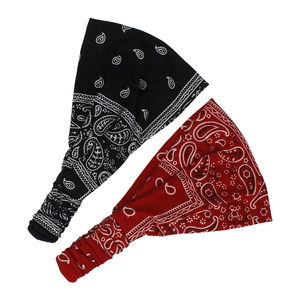 Detailed view of two bohemian paisley headbands in black and red with elastic stretchy back