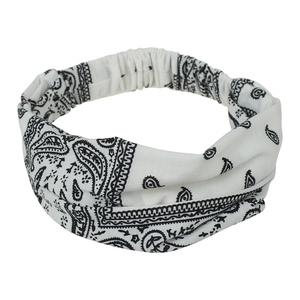 Detailed view of bohemian white headband with black paisley print and elastic band