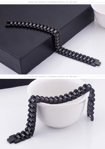 Detail of men's black plated stainless steel bracelet with crystals on watch-style links