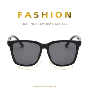 Detail view of stylish square frame sunglasses with light narrow frame and grey lenses
