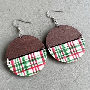 Detail of round wooden earrings with red and green plaid patterns in Bohemian style