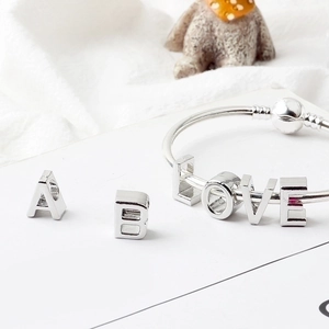 Detailed view of silver alloy letter beads A, B, and LOVE for DIY bracelet making