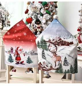 Detail of Christmas chair covers featuring Santa and reindeer prints on dining chairs