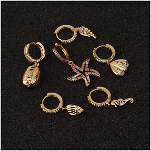 Golden bohemian hoop earrings set with colorful zircon and ocean themed charms