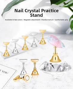 Close-up of gold and silver magnetic nail tip holders on acrylic and crystal bases