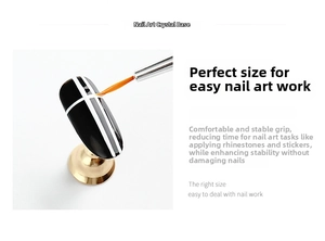 Detail showing acrylic nail art display stand with golden base and painted nail tip