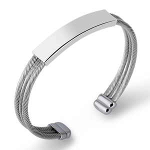 Detailed macro view of silver titanium steel cable bracelet with smooth rectangular plaque