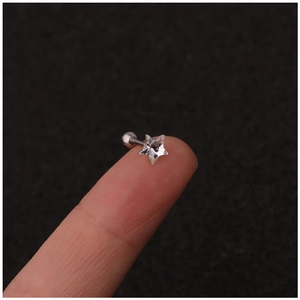 Star-shaped crystal stainless steel cartilage stud earring shown on a fingertip