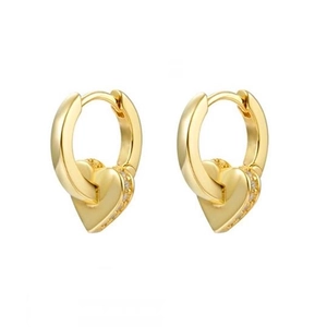 Detail of gold heart earrings with zircon inlay along the side on a minimalist base