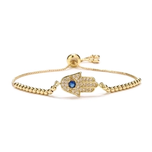 Gold Hamsa Hand bracelet with blue eye zircon and adjustable beaded chain on white background