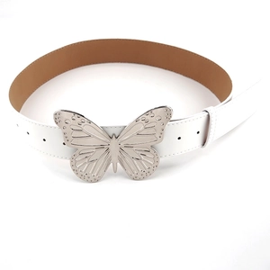 Close-up of white faux leather belt featuring a large silver butterfly metal buckle