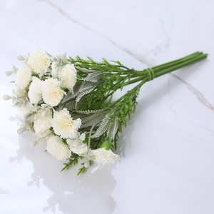 Artificial cream white carnation bouquet on a white marble surface for home decoration