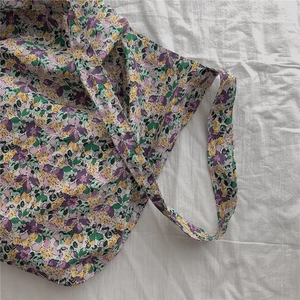 Detailed texture of purple floral cotton tote bag with vintage pastoral pattern