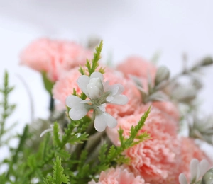 Close-up of pink artificial carnation bouquet with green leaves for home decoration