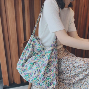 Close-up of floral tote bag with purple patterns and comfortable wide shoulder strap