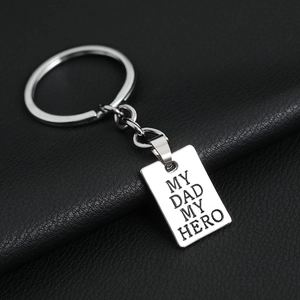 Silver metal keychain with engraved My Dad My Hero tag on a black leather background