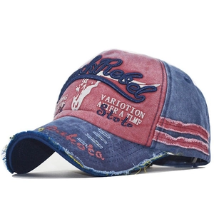 Macro view of vintage washed cotton baseball cap with Rebel 3D embroidery and frayed brim