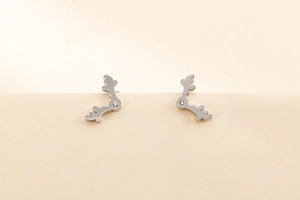 Macro shot of silver reindeer antler stud earrings with sparkling cubic zirconia stones