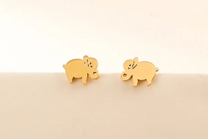 Detail of minimalist golden elephant stud earrings with hollow design and smooth finish
