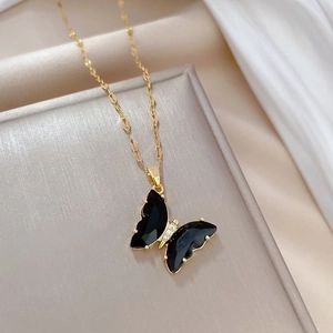 Elegant gold chain necklace featuring a black butterfly pendant with micro diamond inlay