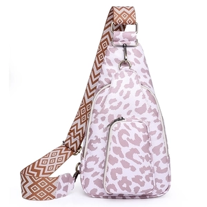 Macro shot of faux leather texture and leopard print on purple crossbody chest bag