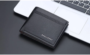 Close-up of minimalist black men's wallet with textured leather and precision stitching