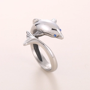 Detailed macro view of 316L stainless steel dolphin ring with blue zircon eyes