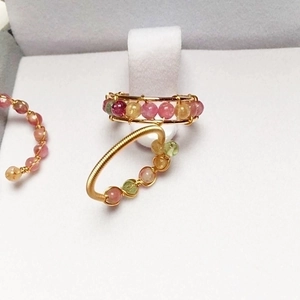 Detail of 14K gold filled wire wrapped rings with colorful tourmaline crystal beads