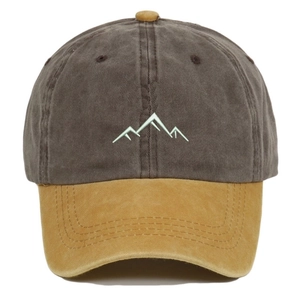 Detailed embroidery of mountain lines on a vintage washed two-tone baseball cap