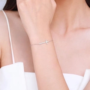 Minimalist S925 sterling silver cross bracelet for women worn on a wrist in elegant style