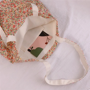 Detail of floral cotton tote bag showing inner pocket and clean creamy white lining