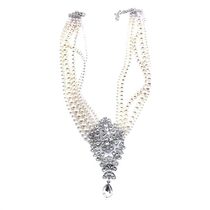 Statement layered pearl and crystal drop choker necklace for women on white background