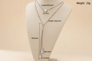 Silver double-layer necklace with heart and figure silhouette charms on black stand