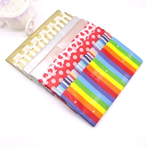 Detailaufnahme von buntem Geschenkpapier mit Punkten, Streifen und Herzmustern