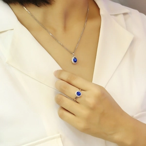 Classic silver halo necklace and ring set with deep blue oval sapphire-style stones
